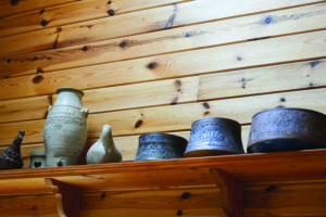 Pieces of pottery art on a shelf.