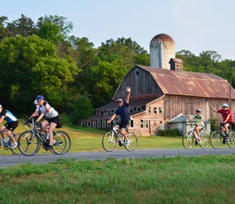 Group of people riding bike on a trail in the country.