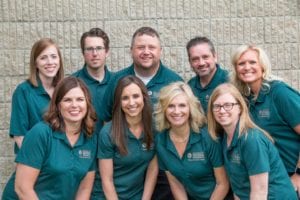 UMVRDC Staff photo. Nine employees in matching green polos. 